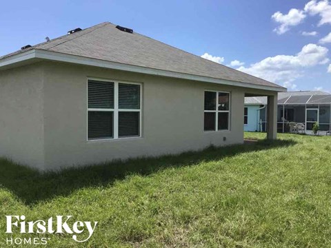 the front of a house with grass in front of it