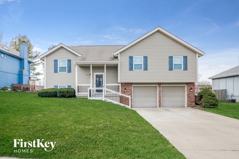 A house with a garage and a driveway is for sale.