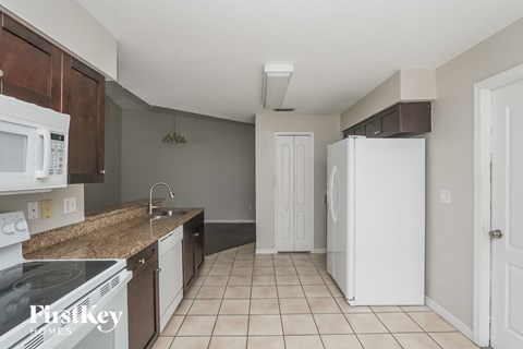 a kitchen with a stove and a refrigerator and a sink