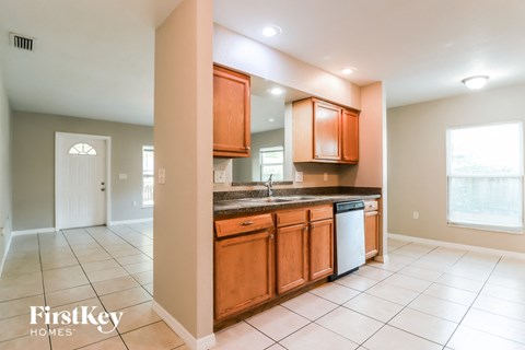 a kitchen with wooden cabinets and a sink and a dishwasher