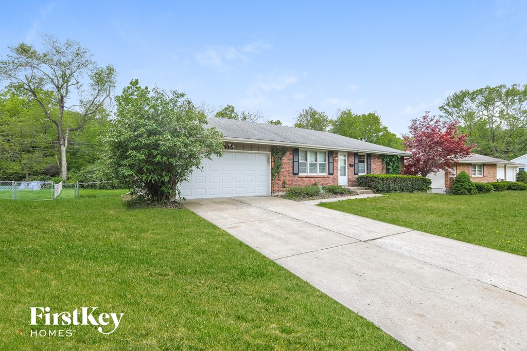 a small brick house with a white garage door