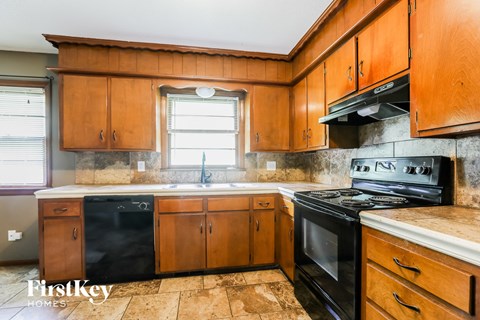 a kitchen with black appliances and wooden cabinets