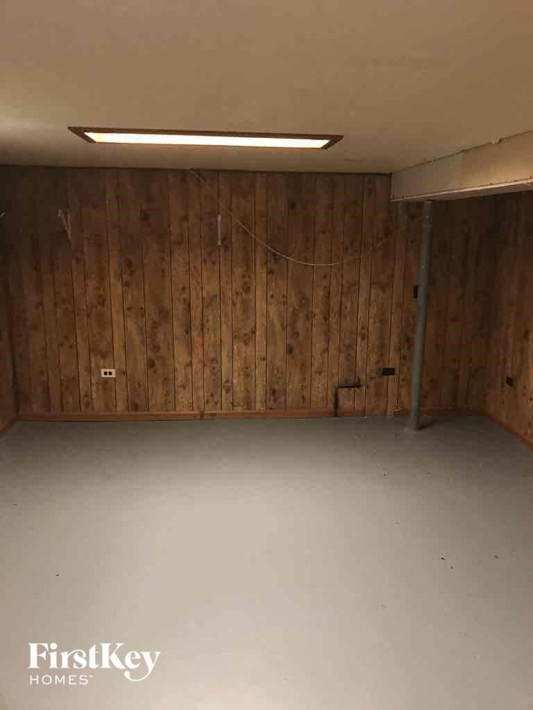 an empty room with wooden walls and a white floor