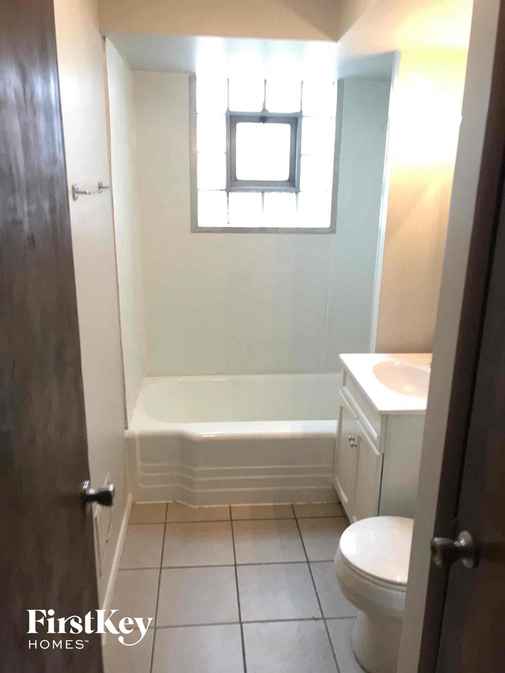 a small bathroom with a toilet and a bath tub