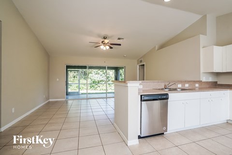 A kitchen with a dishwasher and a ceiling fan.