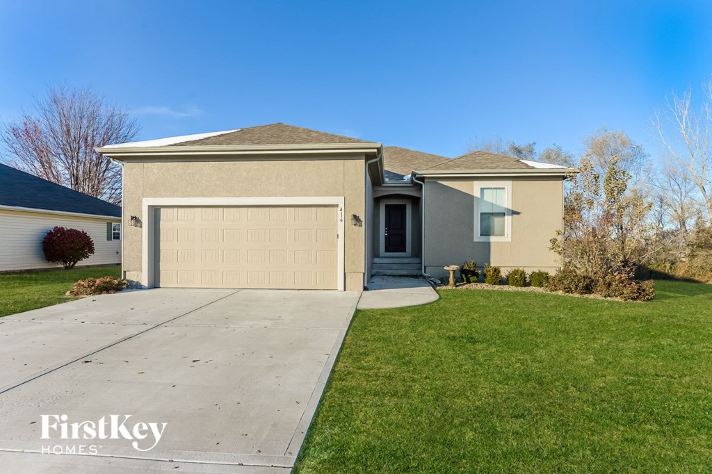 a home with a driveway and a garage door