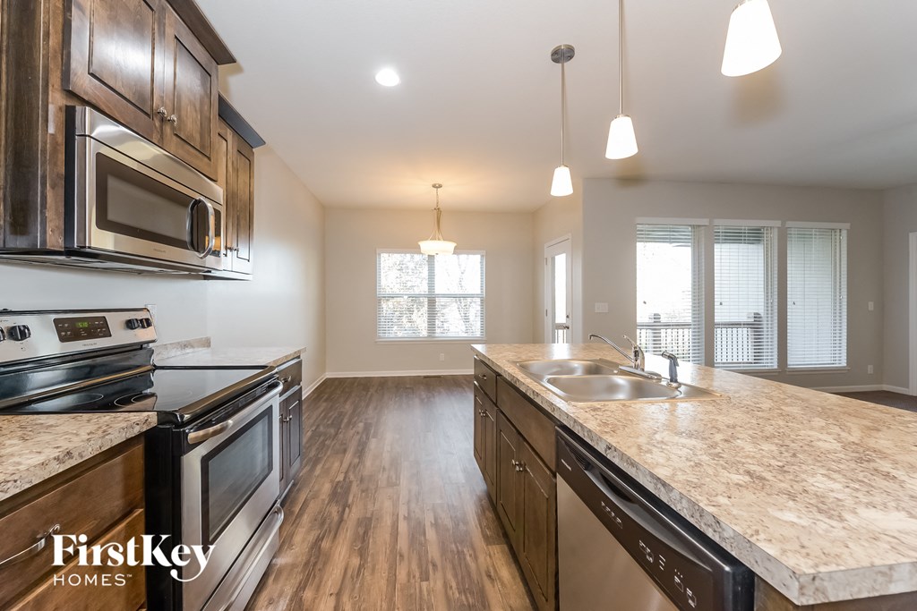 a kitchen with an island and a stove and a sink