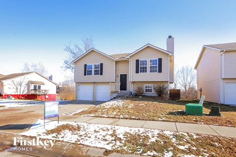a house with a yard with snow on the ground