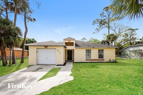 A house with a garage and a driveway is for sale.