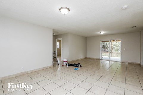 the living room and dining room are spacious with tile flooring and white walls