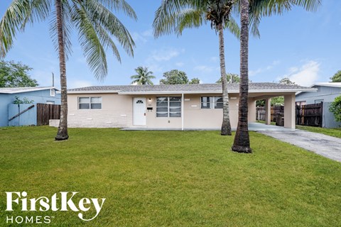a house with palm trees in front of it
