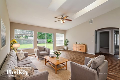 A living room with a grey couch and a wooden coffee table.