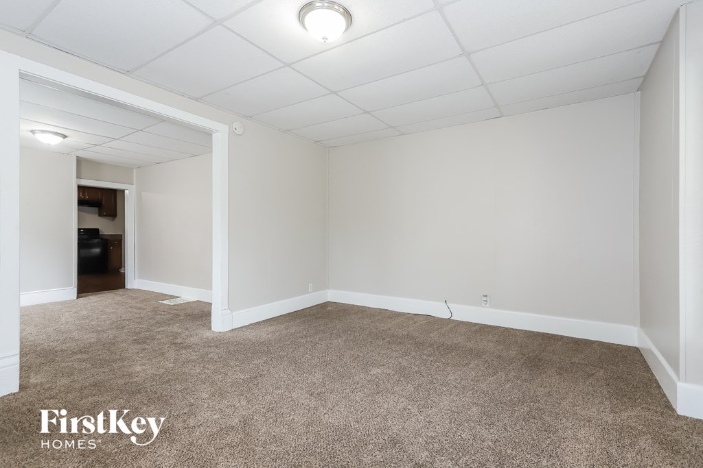 A room with a carpeted floor and white walls.