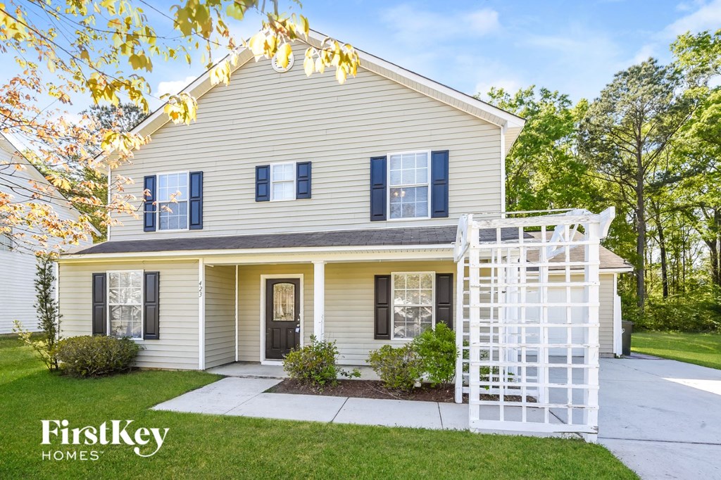 a white house with a white fence in front of it