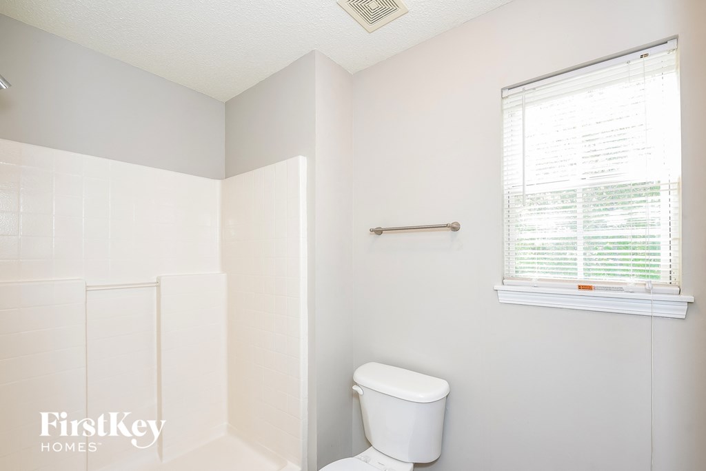 a small bathroom with a toilet and a window