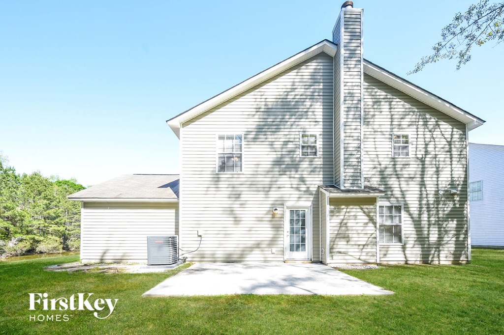 an old with a white house and a lawn