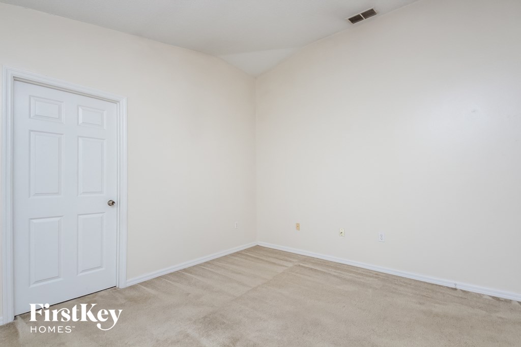 a room with white walls and a white door     and a carpet