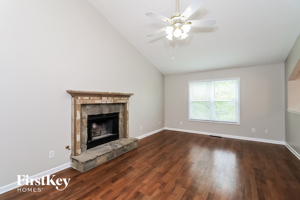 a living room with a fireplace and wooden floors