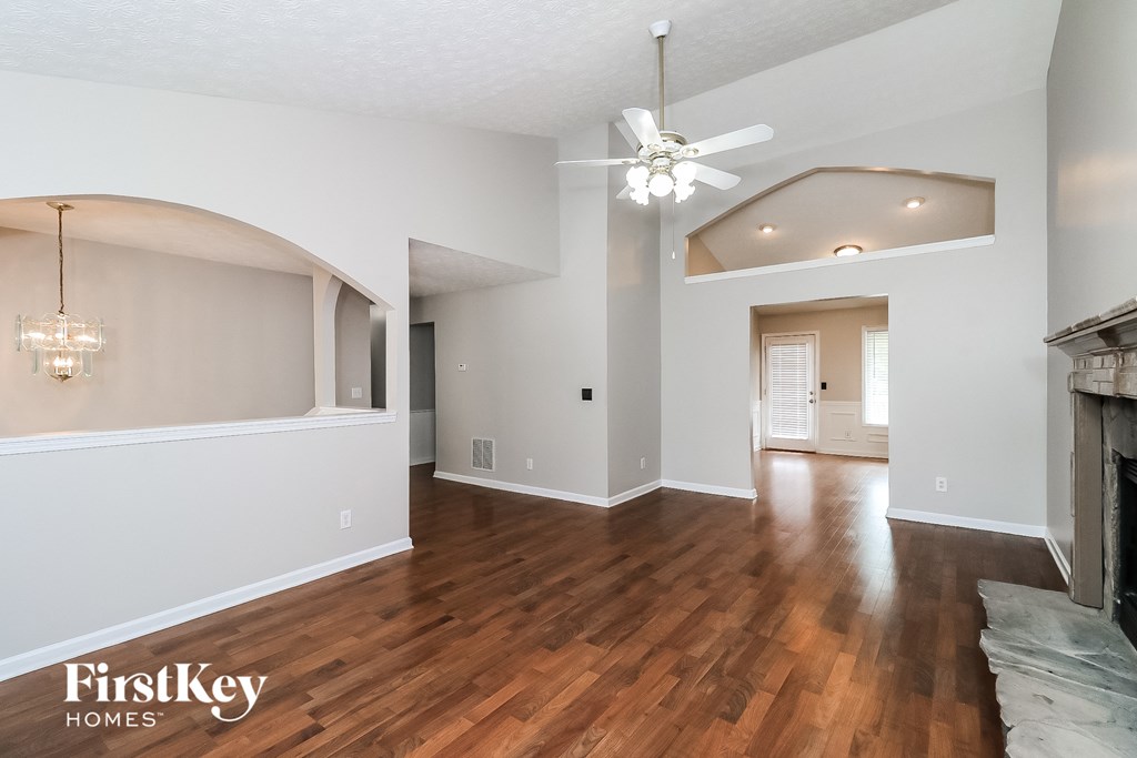 a living room with hardwood floors and a ceiling fan