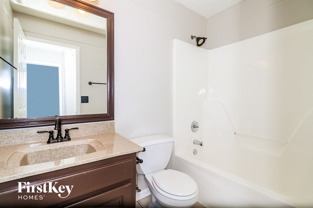 a bathroom with a sink and a toilet and a bath tub