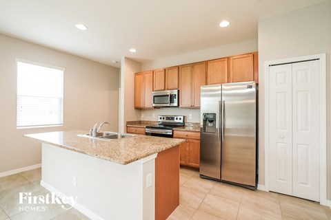 a kitchen with stainless steel appliances and a granite counter top