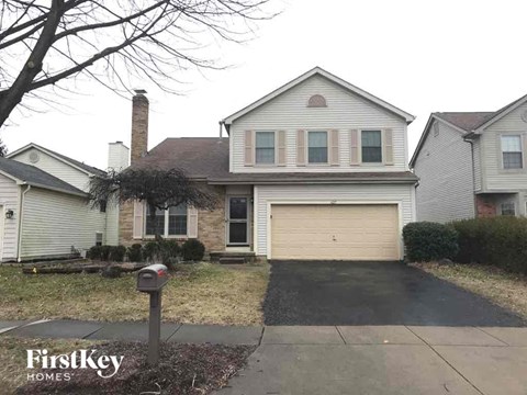 a house with a garage door and a driveway