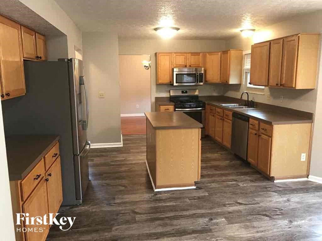 a kitchen with wooden cabinets and stainless steel appliances