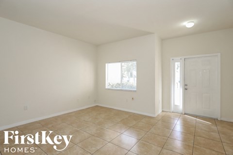 A room with a tiled floor and a door.