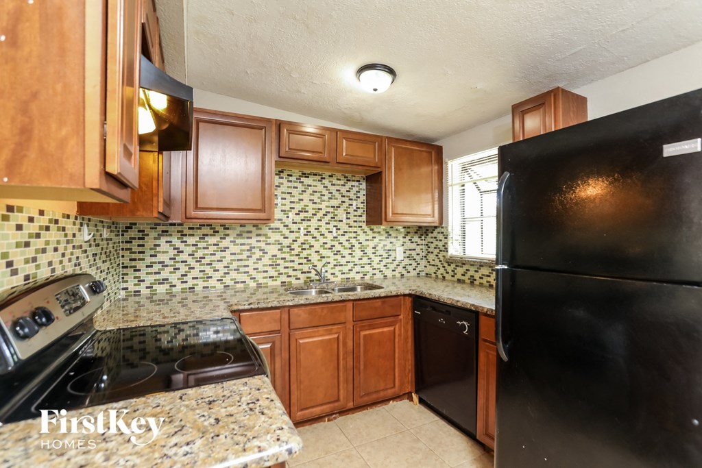 a kitchen with black appliances and wooden cabinets