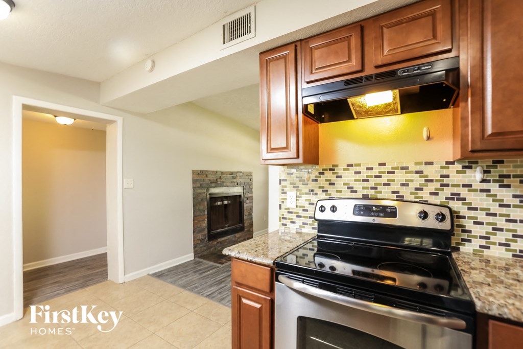 a kitchen with stainless steel appliances and a fireplace