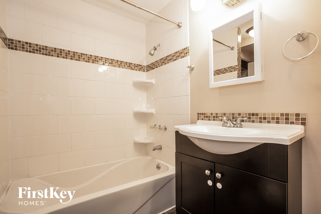 a small bathroom with a sink and a bath tub