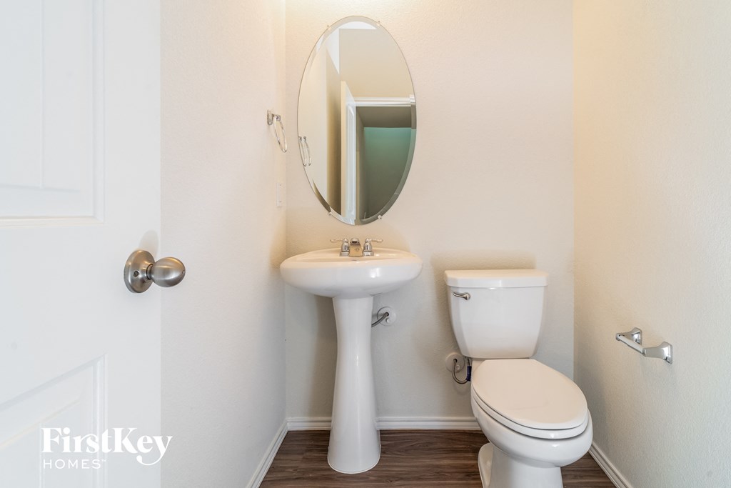 a bathroom with a toilet and a sink and a mirror