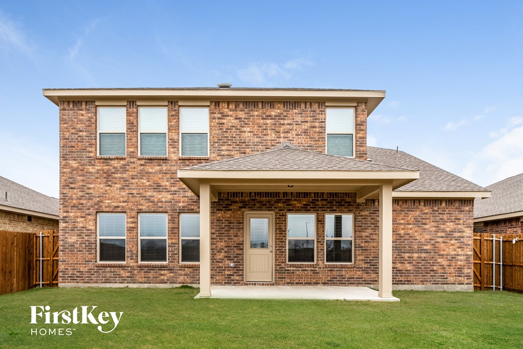 a brick house with a white door and a porch