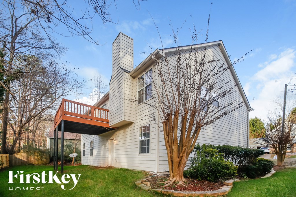 a white house with a deck on top of it