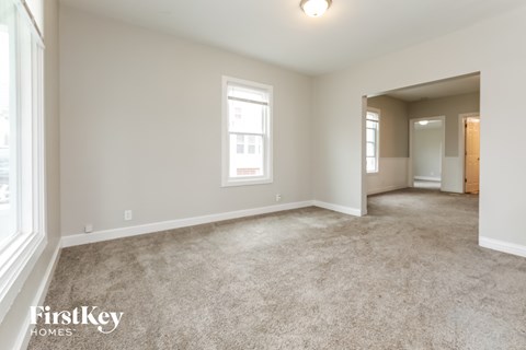 a spacious living room with carpet and a large window