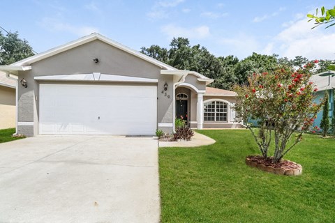 a house with a driveway and a white garage door