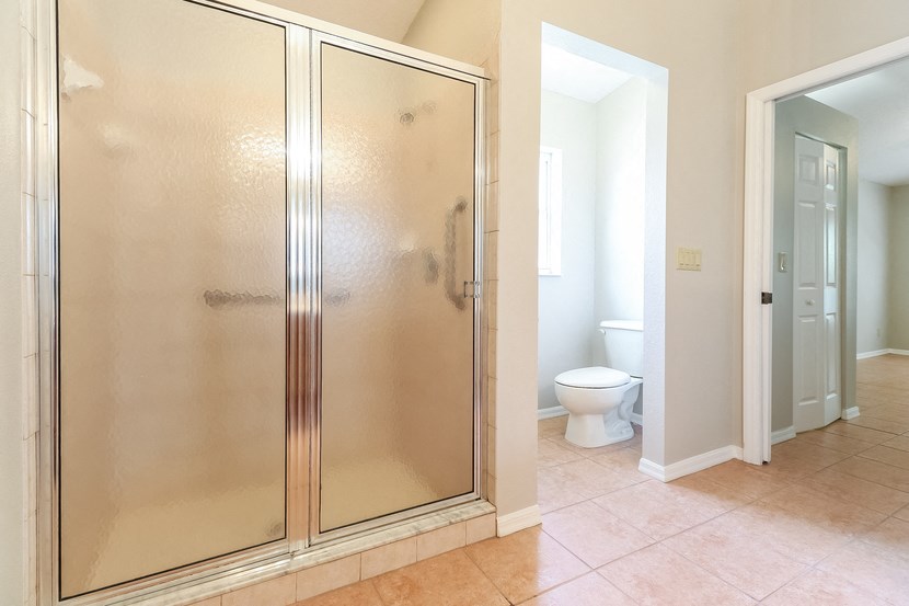 a bathroom with a shower and a toilet in it