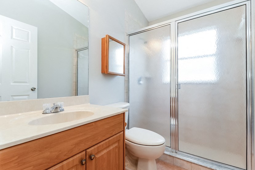 a bathroom with a shower and a sink and a toilet
