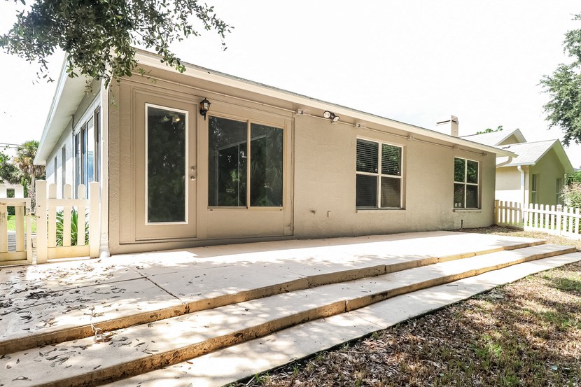 the back of a house with a deck and a porch