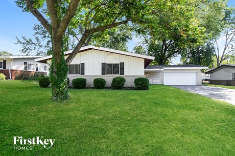 A house with a white garage door is for sale.