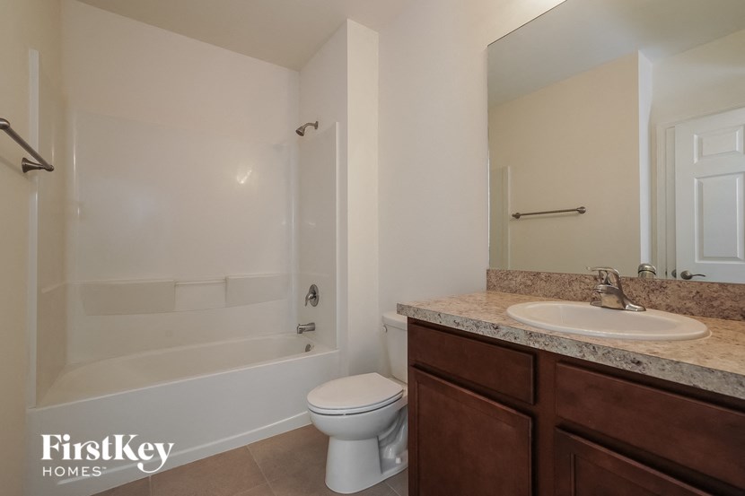 a bathroom with a sink toilet and a bath tub
