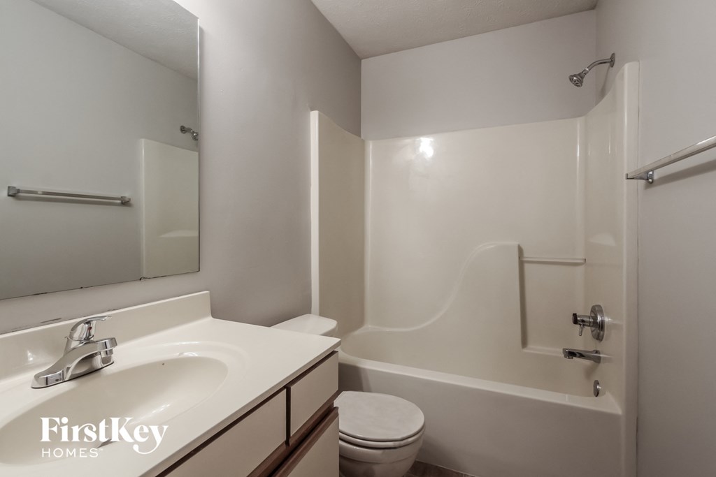 a bathroom with a sink and a toilet and a shower