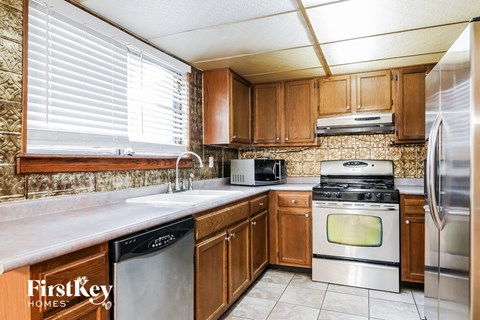 A kitchen with wooden cabinets and stainless steel appliances.