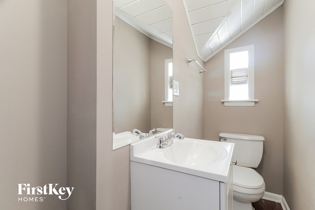 A white sink and toilet in a small bathroom.