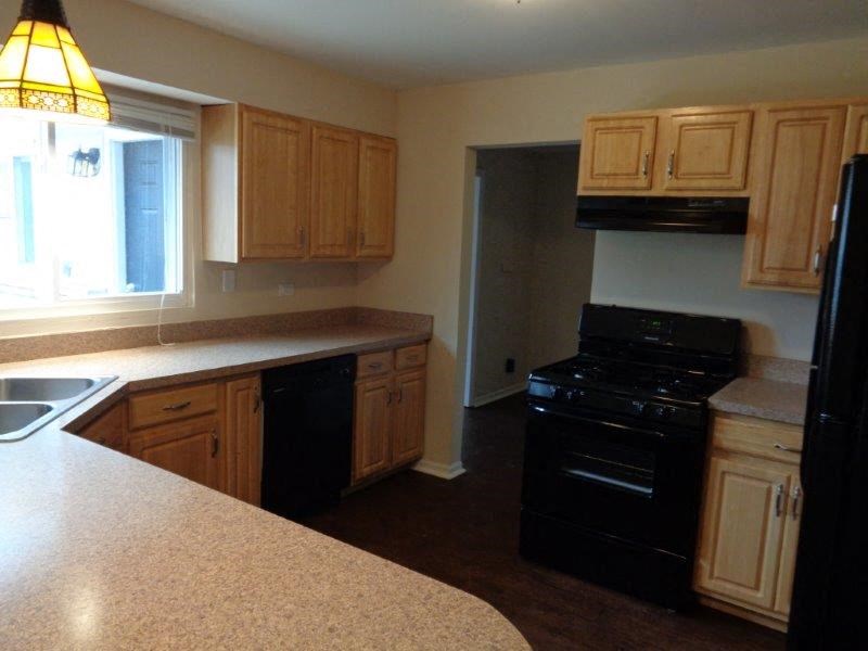 a kitchen with a black stove and a counter top