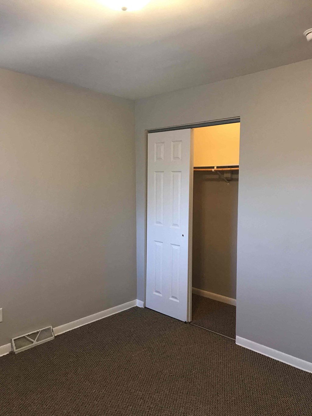 a room with a closet and a white door