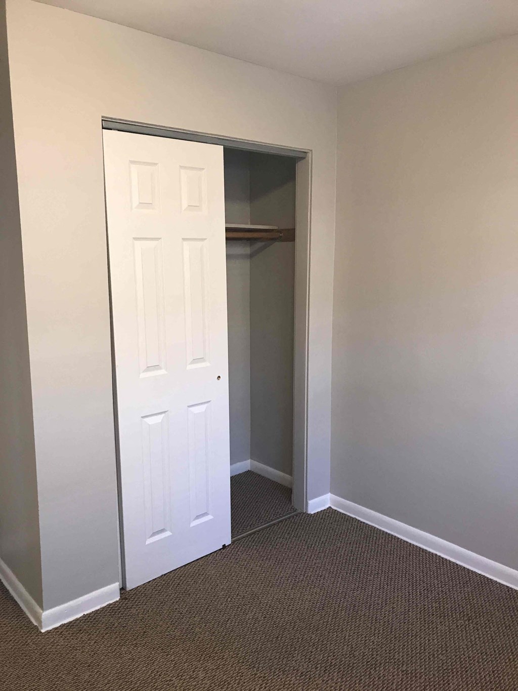 a room with a closet and a white door