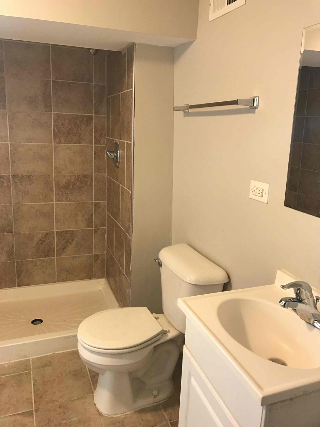 a bathroom with a toilet and a sink and a shower