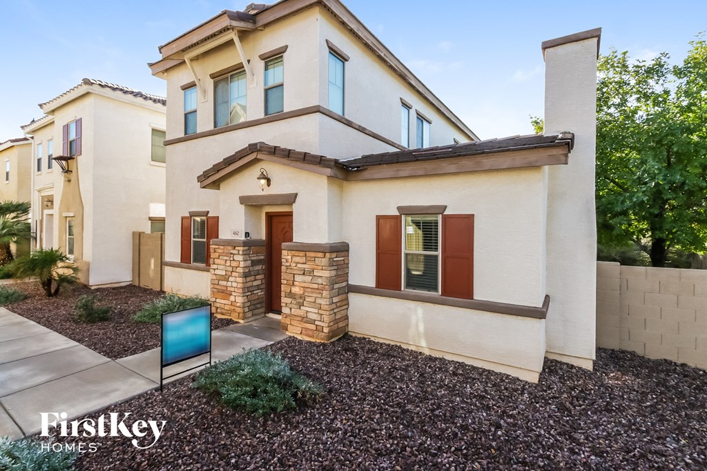 a house with a sidewalk and a sign in front of it