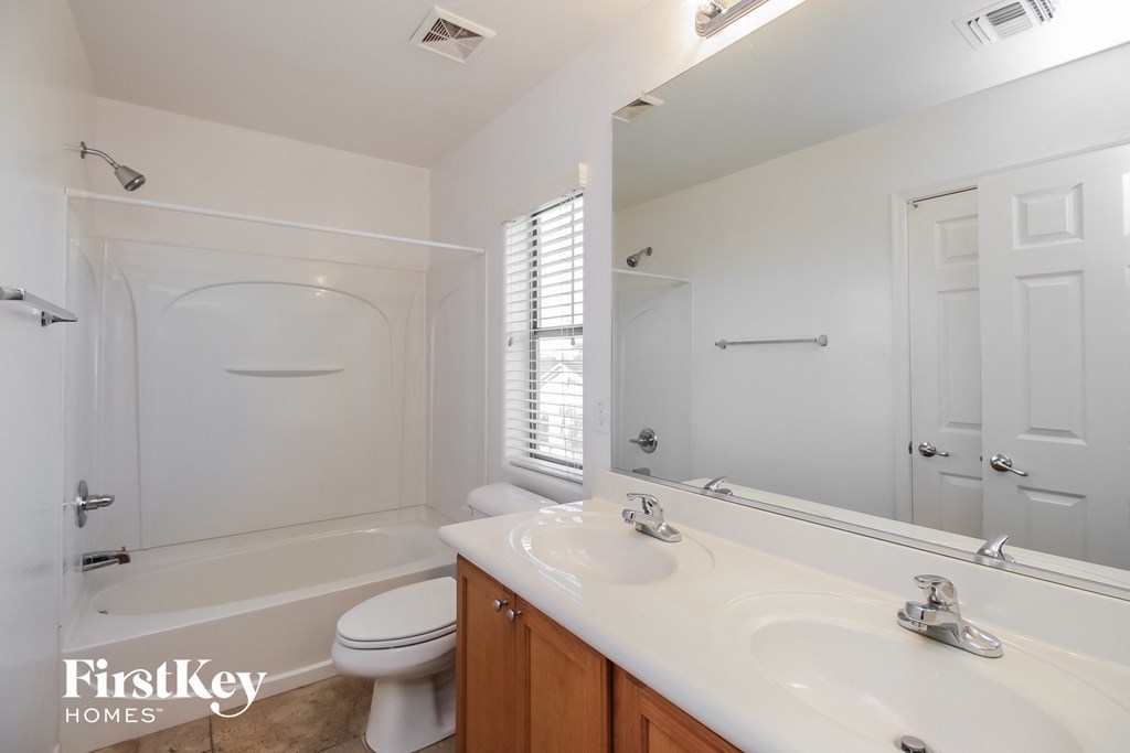 a bathroom with a sink and a toilet and a bath tub